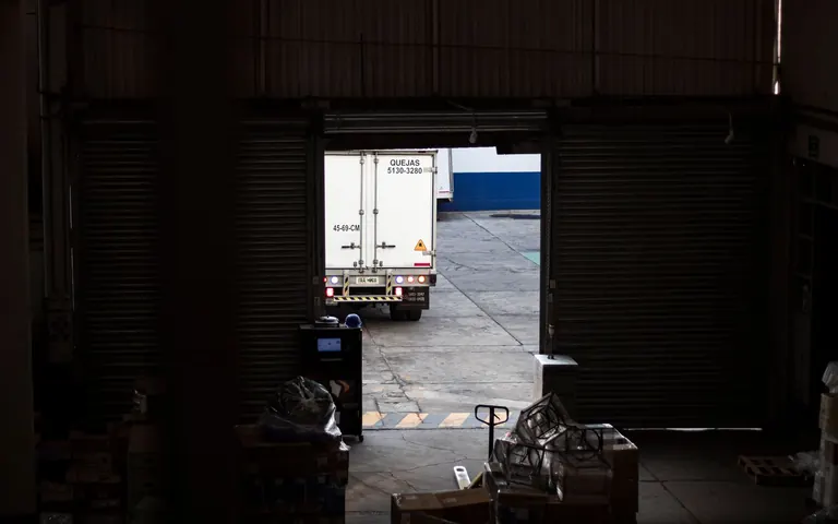 Freight truck leaving an industrial warehouse loading dock