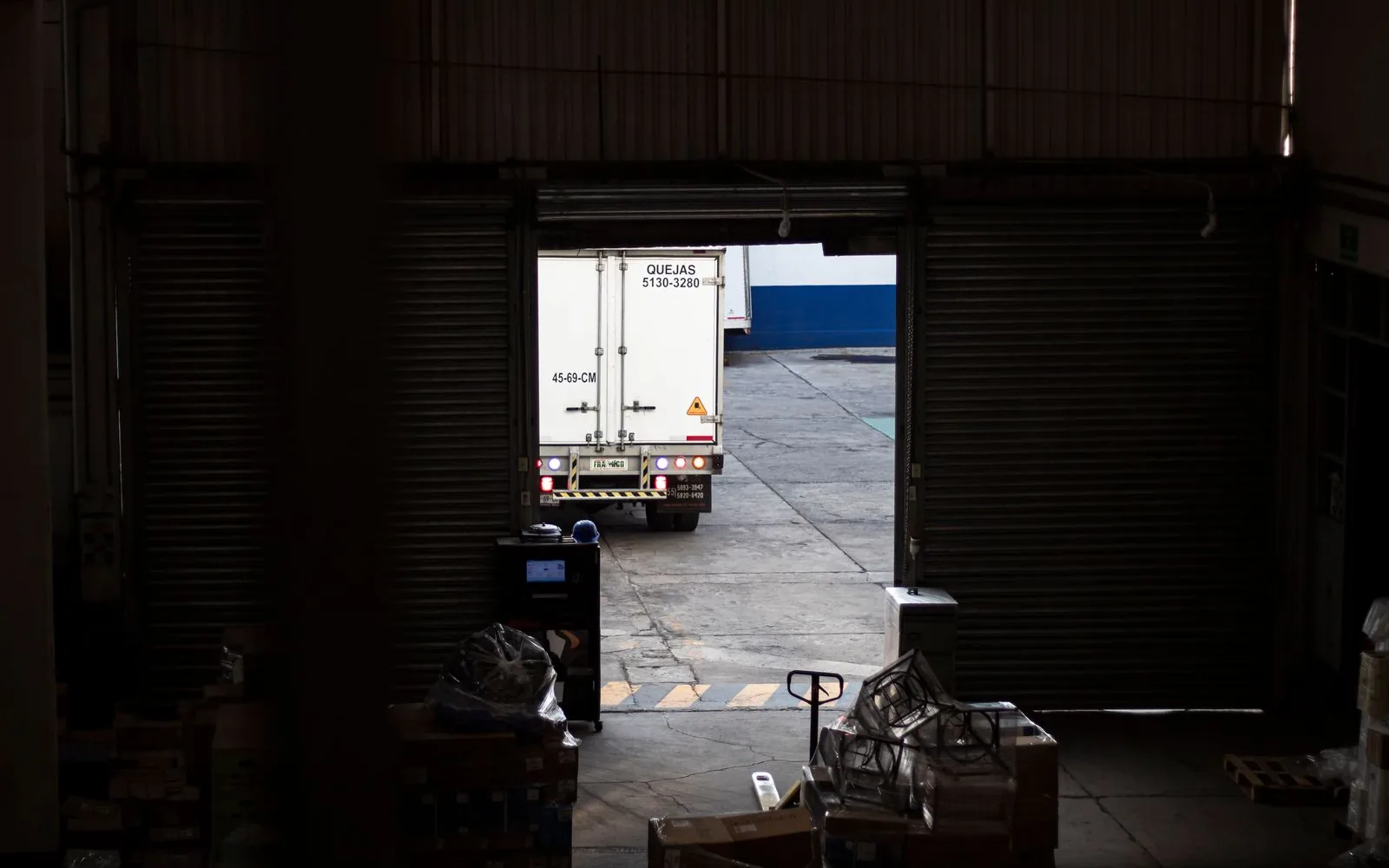 Freight truck leaving an industrial warehouse loading dock