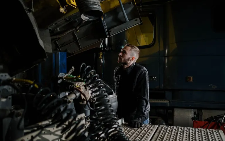 Mechanic inspecting an engine during a vehicle condition check