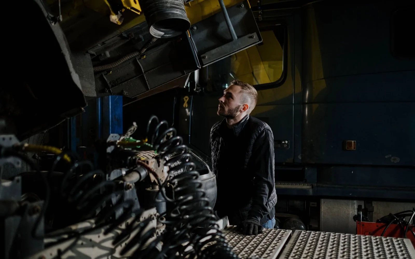 Mechanic inspecting an engine during a vehicle condition check